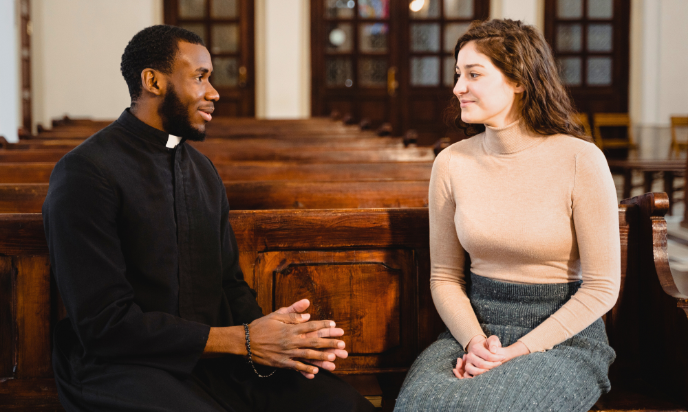 Priest speaking with woman